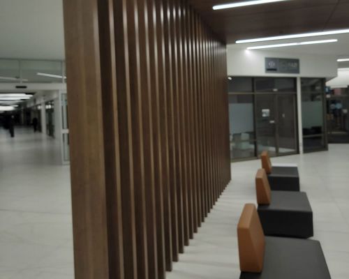 desk and main entrance to office building slot wall and ceiling panels